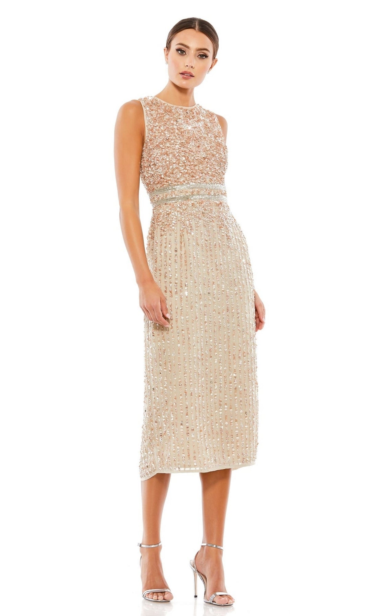 A woman stands against a white background wearing the Mac Duggal 10509 Short Sequin Wedding Guest Dress—sleeveless, knee-length, beige with bead embellishments—paired with silver high-heeled sandals.